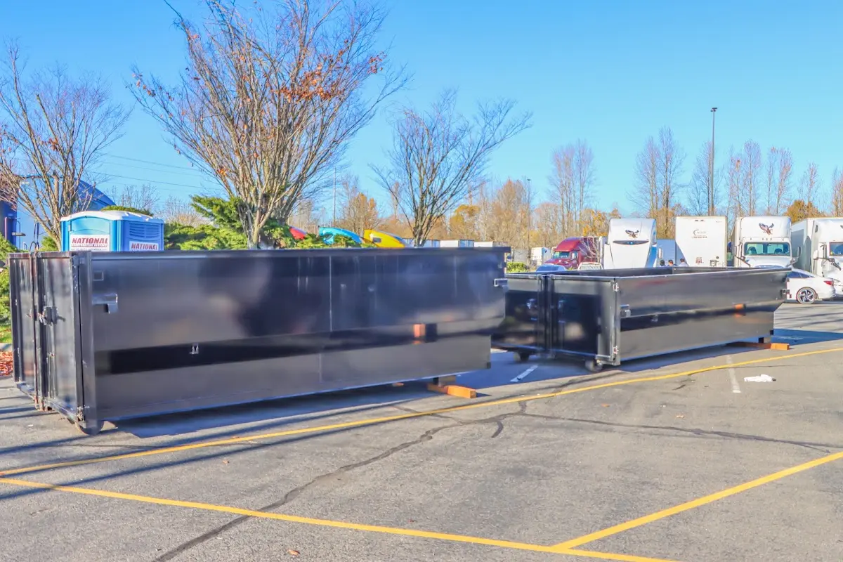 Professional dumpster rental service with roll-off container on residential driveway in Ghent